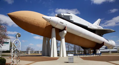 Space Shuttle exhibit showcased against blue skies at the rocket center