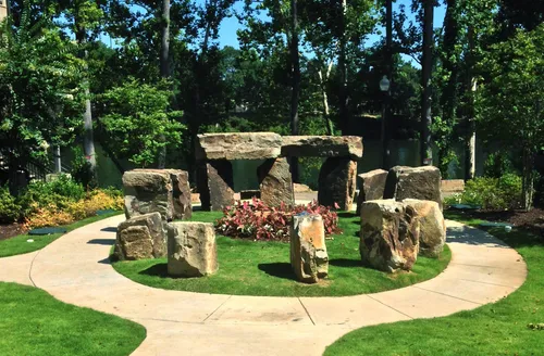 This stone formation creates a miniature Stonehenge-like monument near the parking lot