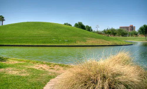 The smooth green hill slopes gently toward the west end of the lake