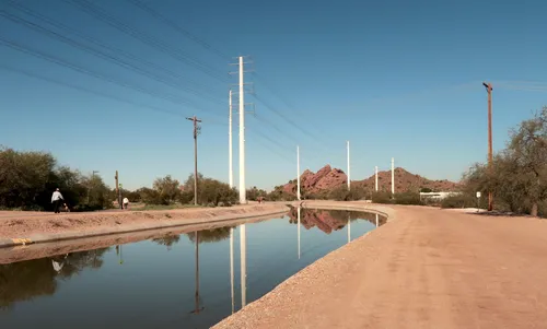 Paths run alongside the Crosscut Canal under a clear Arizona sky