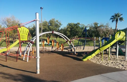 Modern playground equipment featuring climbing structures and sandy areas