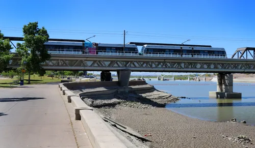 Light rail train at the western edge of the park with Salt River to the right