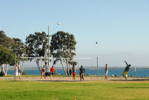 Visitors enjoying volleyball in the park