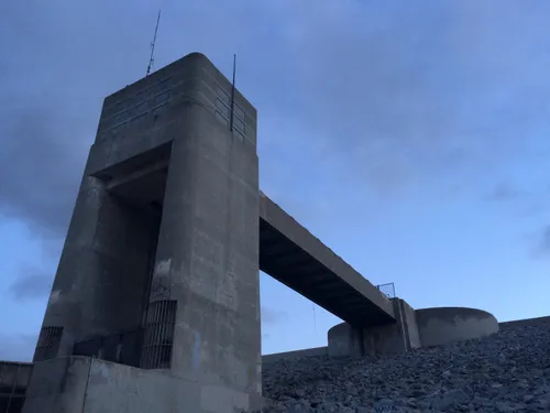 An otherwordly shot of the imposing concrete dam structure
