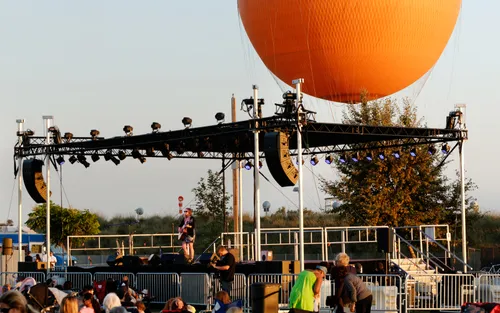 The park's iconic orange helium balloon above a concert stage
