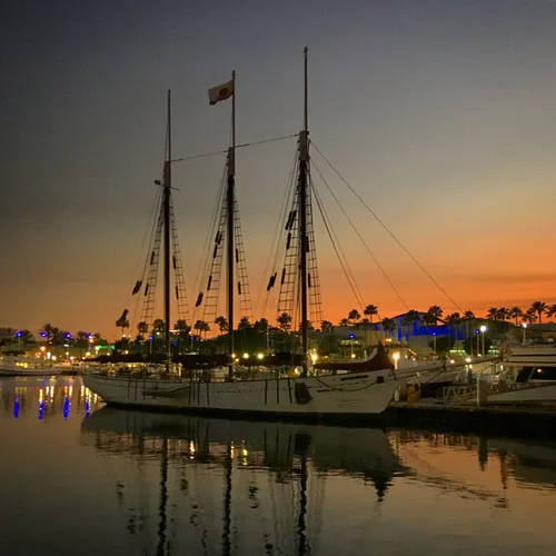 Sailing vessel docked at Rainbow Harbor during sunset