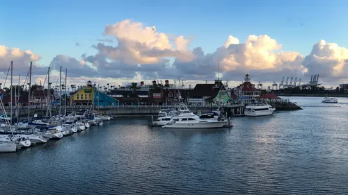 View of boats moored in the marina with clouds overhead