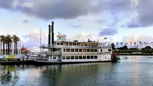 Riverboat with paddlewheel docked along the waterfront