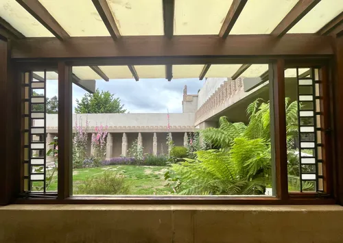 Interior window frames a view of the lush central courtyard