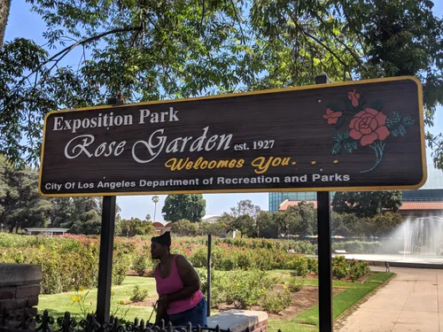 The Exposition Park Rose Garden sign welcomes visitors