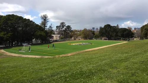 Spacious green lawns and fields under cloudy skies