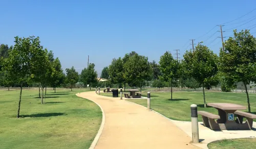 Winding path through the park with adjacent picnic tables