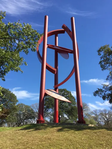 The towering red Cosmos sculpture reaches skyward