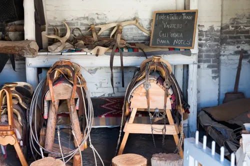 Leather saddles and riding equipment in one of the buildings
