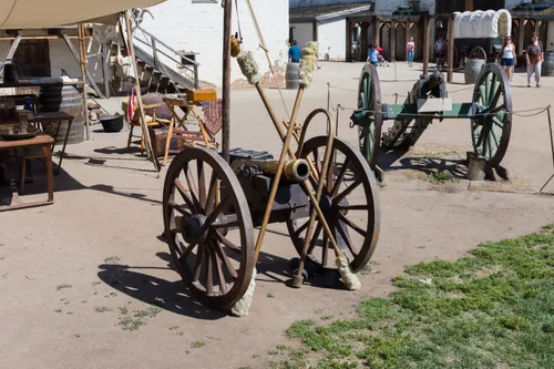 Antique cannons with large wheels in the fort courtyard