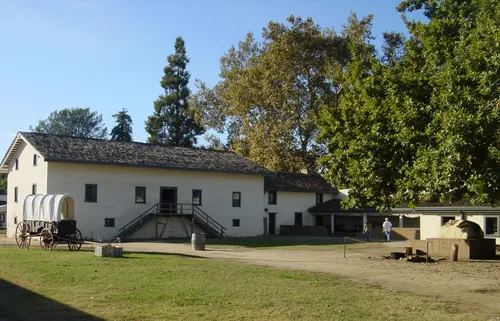 White adobe buildings surrounding the main courtyard of the historic fort