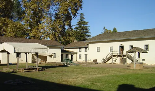 Grassy parade ground flanked by preserved historic barracks