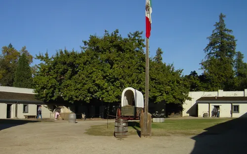 Flagpole and wagon in the center of the historic compound