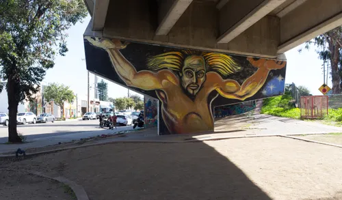 Mural depicting a figure supporting the bridge overhead