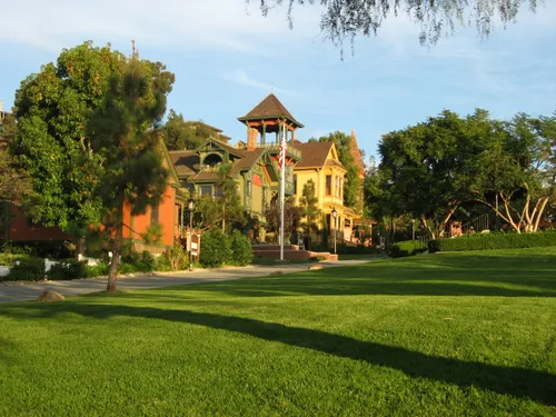 Historic structures sit among lush greenery in the park