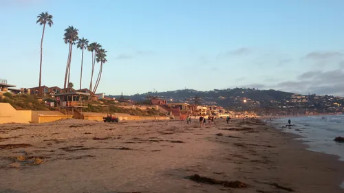 Visitors walking on the sandy beach