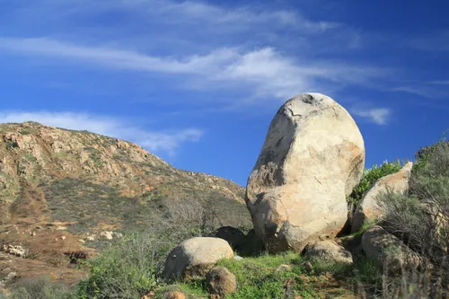 White boulder formation rising alongside mountain trails