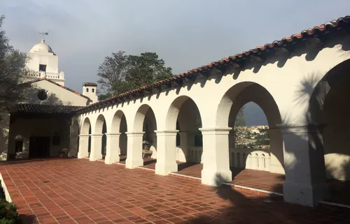 Terracotta walkway alongside the colonial-style arcade