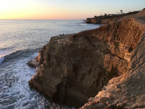 Golden cliffs catching the sunset light along the eroded coastline