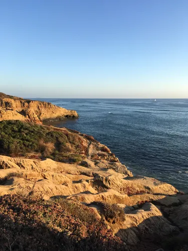 Sun-bathed rock formations overlooking the blue waters