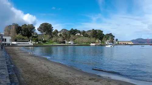Looking west along the shoreline toward tree-covered hills