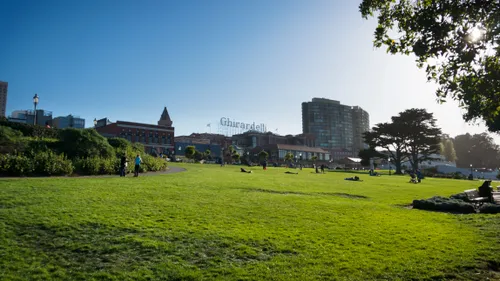 Visitors relax on the sloped open lawn
