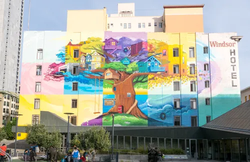 A large mural visible on a building behind the playground