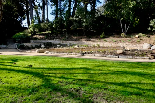 Green lawn area with walking path and trees