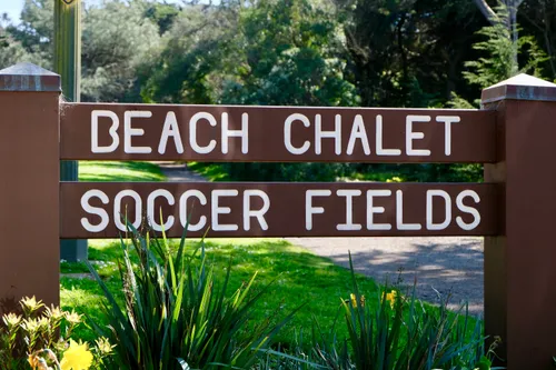 Wooden sign surrounded by plantings