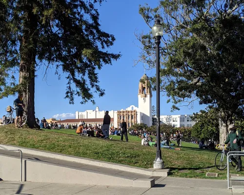 Visitors on the grass with Mission High School in the background