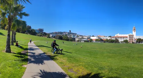 Gently sloping lawn area with visitors enjoying the empty park
