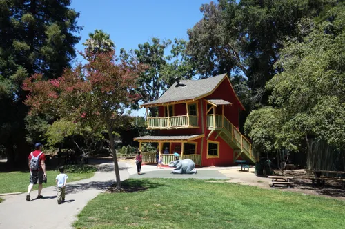 The colorful Crooked House nestled among trees
