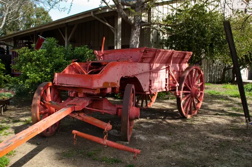 Antique fire wagon painted bright red stands on display