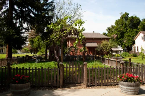 Historic home with picket fence and garden