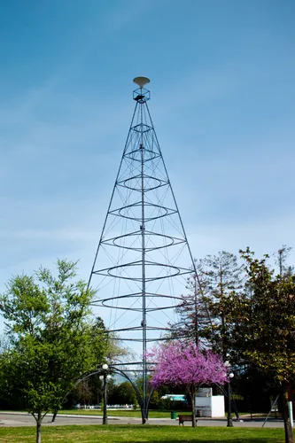 Replica of San Jose's Electric Light Tower rises against blue sky