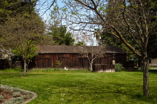Peaceful area with shade trees and barn