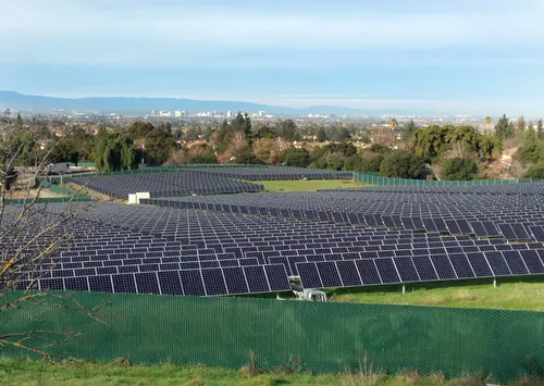 Westward view across a solar panel array toward San Jose