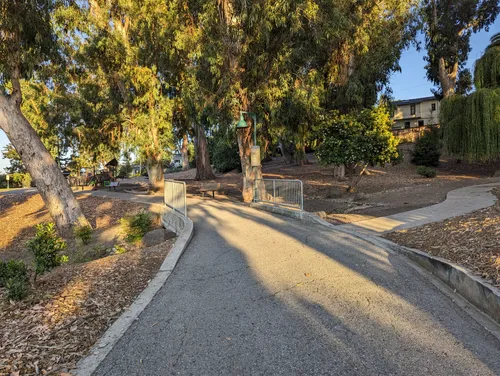 Walking path with afternoon shadows cast by surrounding trees