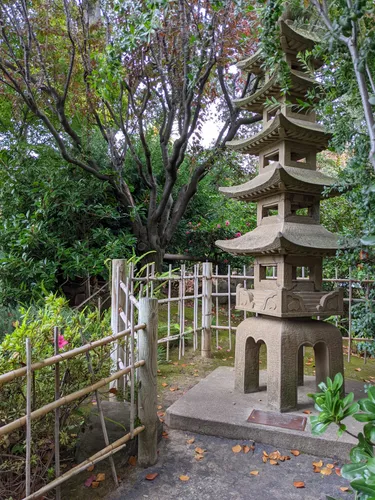 Multi-tiered pagoda structure nestled among flowering trees
