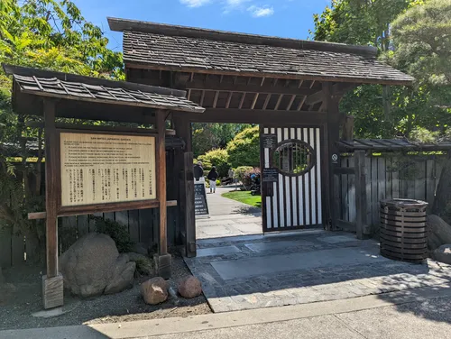 Traditional wooden entrance gate with informational signage