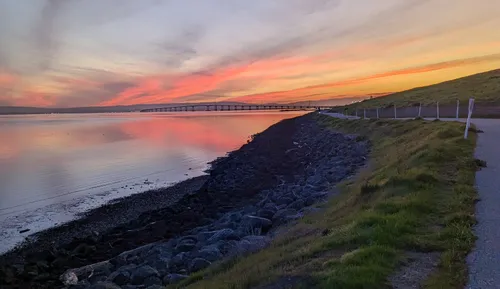 The Bay Trail extending into the distance with San Mateo-Hayward Bridge across the water