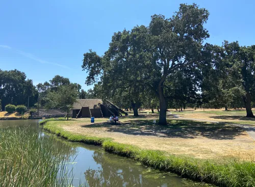 Oak Grove Lake with the amphitheater and sprawling trees visible along the shore