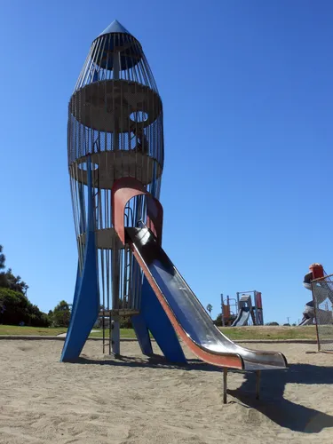 Rocket ship playground structure featuring a slide