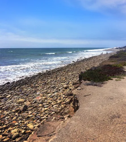 Rocky shoreline meets the ocean waves in this section of the beach