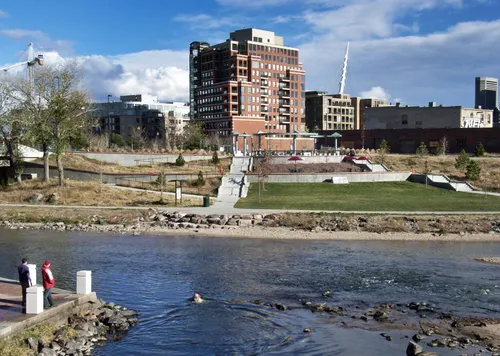 The park grounds visible beyond the river